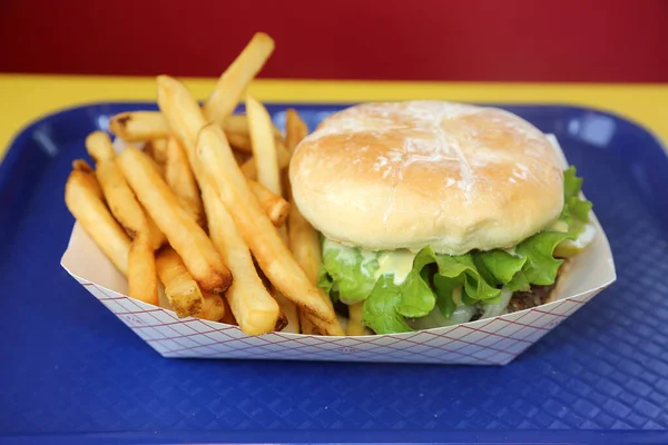 Cheese Burger. French Fries. A Deluxe Cheese Burger with French Fries. Hamburger with Cheese Tomato, Onion and Secret Sauce. Restaurant Lunch Special. Cheese Burger and Fries Special. gourmet cheeseburger and french fries. Cheese burger. Fries.