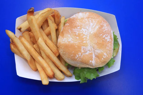 Cheese Burger. French Fries. A Deluxe Cheese Burger with French Fries. Hamburger with Cheese Tomato, Onion and Secret Sauce. Restaurant Lunch Special. Cheese Burger and Fries Special. gourmet cheeseburger and french fries. Cheese burger. Fries.