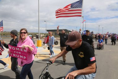 Başkan Donald Trump. Huntington Sahili, CA - 25 Mart 2017: Amerika 'yı Tekrar Harika Yap Yürüyüşü. Cumhuriyetçi başkan Donald Trump 'ın destekçileri ve protestocuları Huntington Beach' teki MAGA yürüyüşünde tezahürat ve alay ediyorlar. Başkan Trump Destekçileri. Trump için. 