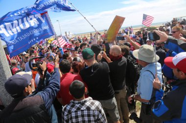 Huntington Sahili, CA - 25 Mart 2017: Amerika 'yı Tekrar Harika Yap Yürüyüşü. Cumhuriyetçi başkan Donald Trump 'ın binlerce destekçisi Huntington Sahili' ndeki bir MAGA yürüyüşünde bayrak salladı. Birkaç Anti-Trump protestocusu ruhlarını göstermek için geldi.. 