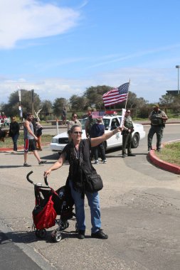 Huntington Sahili, CA - 25 Mart 2017: Amerika 'yı Tekrar Harika Yap Yürüyüşü. Cumhuriyetçi başkan Donald Trump 'ın binlerce destekçisi Huntington Sahili' ndeki bir MAGA yürüyüşünde bayrak salladı. Birkaç Anti-Trump protestocusu ruhlarını göstermek için geldi.. 