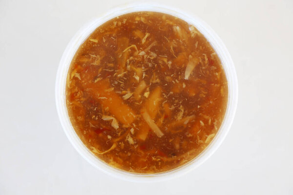 Chinese Hot & Sour Soup. Chinese food Hot and Sour Soup in a white bowl with spoon. Soup is a tasty part of any Chinese Lunch or Dinner. Enjoy your Hot & Sour Soup today. Egg Flower is also good. Hot and Sour Soup. Lunch. Dinner. Food. Chinese food.