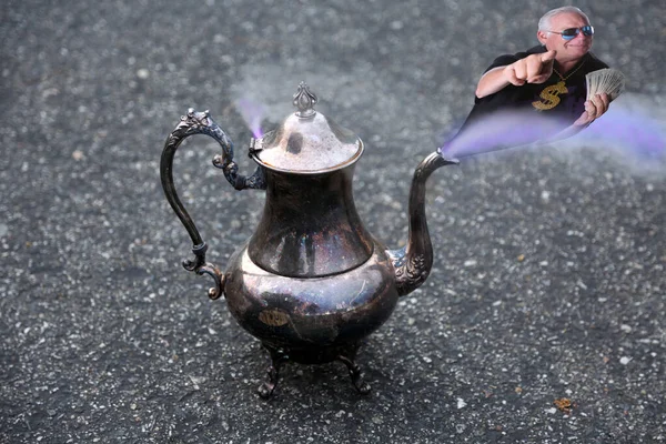 Genie in a bottle. A magic lantern with a genie coming out to grant a wish. Magic lamp from the story of Aladdin with Genie appearing in smoke concept for wishing, luck and magic. Wish Lamp.  Genie Coming Out Of The Bottle. Magic Lantern. 3 Wishes.