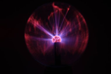 Close up view of a Plasma lamp. The plasma lamp was invented by Nikola Tesla, during his experimentation with high-frequency currents in an evacuated glass tube for the studying high voltage.