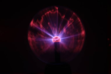 Close up view of a Plasma lamp. The plasma lamp was invented by Nikola Tesla, during his experimentation with high-frequency currents in an evacuated glass tube for the studying high voltage.