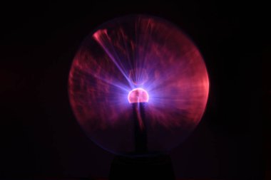 Close up view of a Plasma lamp. The plasma lamp was invented by Nikola Tesla, during his experimentation with high-frequency currents in an evacuated glass tube for the studying high voltage.