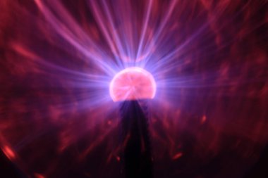 Close up view of a Plasma lamp. The plasma lamp was invented by Nikola Tesla, during his experimentation with high-frequency currents in an evacuated glass tube for the studying high voltage.