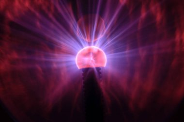 Close up view of a Plasma lamp. The plasma lamp was invented by Nikola Tesla, during his experimentation with high-frequency currents in an evacuated glass tube for the studying high voltage.