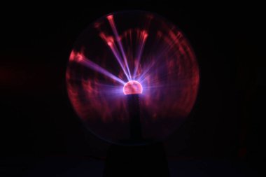 Close up view of a Plasma lamp. The plasma lamp was invented by Nikola Tesla, during his experimentation with high-frequency currents in an evacuated glass tube for the studying high voltage.