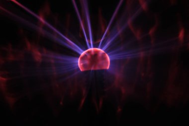 Close up view of a Plasma lamp. The plasma lamp was invented by Nikola Tesla, during his experimentation with high-frequency currents in an evacuated glass tube for the studying high voltage.