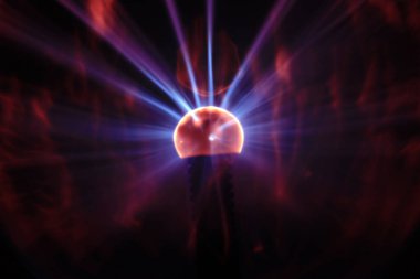 Close up view of a Plasma lamp. The plasma lamp was invented by Nikola Tesla, during his experimentation with high-frequency currents in an evacuated glass tube for the studying high voltage.