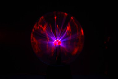 Close up view of a Plasma lamp. The plasma lamp was invented by Nikola Tesla, during his experimentation with high-frequency currents in an evacuated glass tube for the studying high voltage.