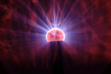 Close up view of a Plasma lamp. The plasma lamp was invented by Nikola Tesla, during his experimentation with high-frequency currents in an evacuated glass tube for the studying high voltage.