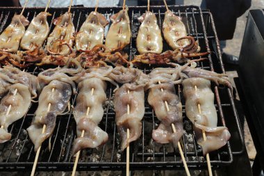 BBQ Squid on a stick. Squid being barbecued on a bamboo stick for lunch and snacks at the 2018 TET Festival aka Lunar New Year. Lunar New Year of the Dog.