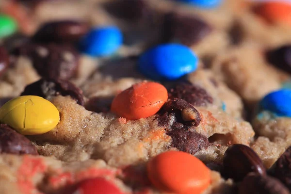 Big Close Up of a Fresh Baked Cookie with colorful candy coated chocolate drops