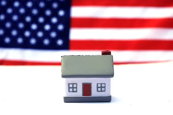 House with American flag. American Real Estate concept. United States Housing Market Concepts.