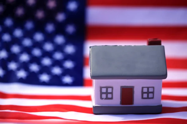 House with American flag. American Real Estate concept. United States Housing Market Concepts.