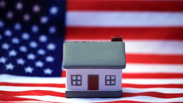 House with American flag. American Real Estate concept. United States Housing Market Concepts.