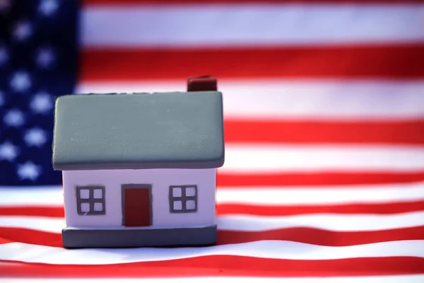 House with American flag. American Real Estate concept. United States Housing Market Concepts.