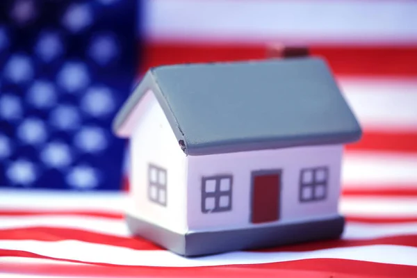 House with American flag. American Real Estate concept. United States Housing Market Concepts.