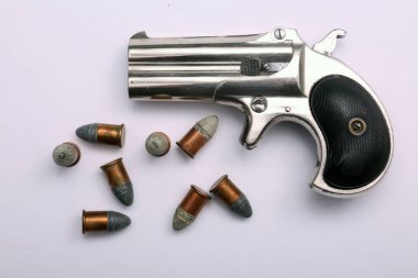 Antique Vintage 1887 pocket pistol with original. 41 caliber black powder bullets isolated on white with room for text.