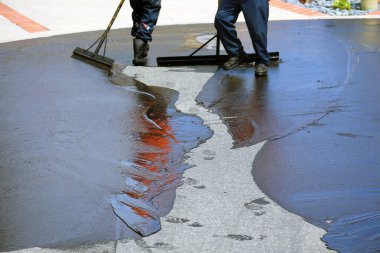 Private drive way, street rehabilitation and slurry seal project finished with crews expertly applying the slurry seal. Re-surfaced Cul-de-sac shown with unidentifiable crew working