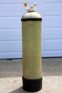 Deionized water filter. Pure Water Filter outside in a driveway. Deionized water is used for industrial and commercial uses including window washing and pharmaceutical mfg.