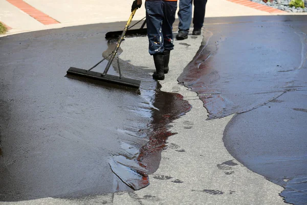 Private drive way, street rehabilitation and slurry seal project finished with crews expertly applying the slurry seal. Re-surfaced Cul-de-sac shown with unidentifiable crew working