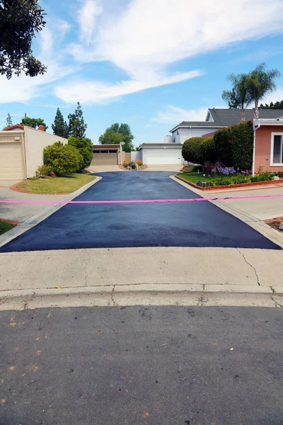 Private drive way, street rehabilitation and slurry seal project finished with crews expertly applying the slurry seal. Re-surfaced Cul-de-sac shown with unidentifiable crew working