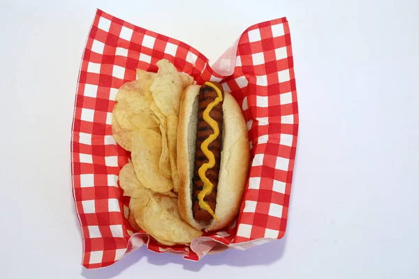 Hot Dog. America's favorite snack food the Hot Dog. Hot Dog in Bun with Mustard. Isolated on white. Room for text.