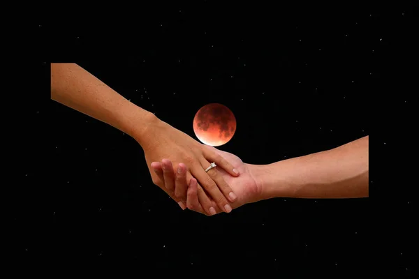 Engagement. A couple holds hand with the full moon eclipse sky background. Romantic Engagement with wedding right and full moon in lunar eclipse.