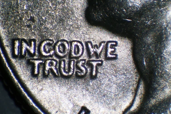 IN GOD WE TRUST. Microscopic View of the worlds in god we trust on a us quarter dollar.