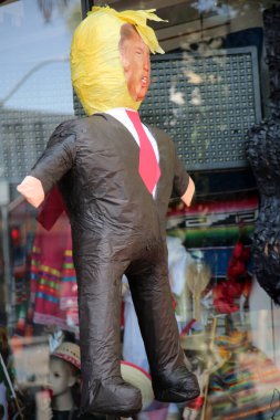8-27-2018 Santa Ana, California: Piata of President Donald J. Trump hangs for sale at a store front. Offensive objects like this are allowed because of the laws of the united states.