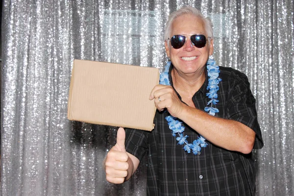 man with blank sign. A Man in a Photo Booth with a Blank Sign. Room for text. Silver sequin background photo booth.