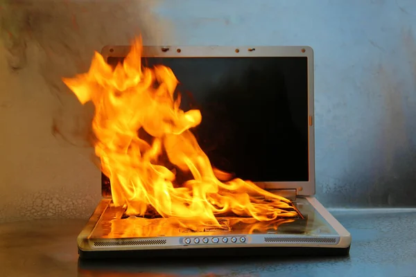 Laptop Damage. Laptop on fire and flames. Computer Repair. Flaming Fire laptop computer.