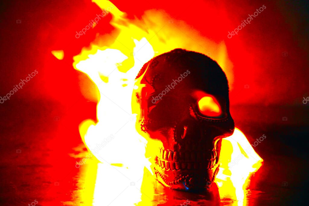 Halloween. Human Skull on fire. Fire and Flames of HELL Burn a Human Skull for all of eternity. Fire and Flame. skull in flame on dark black background. the symbol of dead. Hell Fire. Human Soul burning in Hell Fire. Fire and Flame. Satan. evil fire.