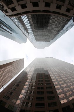 Skyscrapers seen from the ground up. Sky Scrapers photographed through a Fish Eye lens. Downtown buildings in any large city. Los Angeles, Chicago, New York, Tokyo.