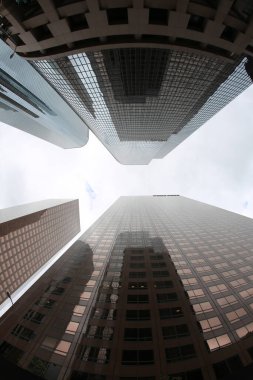 Fish Eye Lens View of Skyscrapers seen from the ground up. Sky Scrapers photographed through a Fish Eye lens. Downtown buildings in any large city. Los Angeles, Chicago, New York, Tokyo.