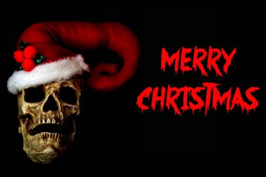 Cadılar Bayramı. Noel zamanı. Noel Baba Kafatası. İnsan kafatası Noel Baba şapkası takar. Noel hem ölüler hem de ölmeyenler tarafından kutlanır. Mutlu noeller. Mutlu Cadılar Bayramı. Şeytani Noel Kafatası. Noel Baba Şapkalı İnsan Kafatası. Noel Baba şapkalı insan kafatası. 