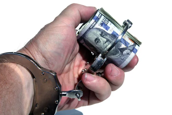 Human Hand Holds Money with Handcuffs. American Money Locked up with Hand Cuffs. Isolated on white. Room for text. Financial and Banking Concepts. Money or savings locked up for the future concepts.