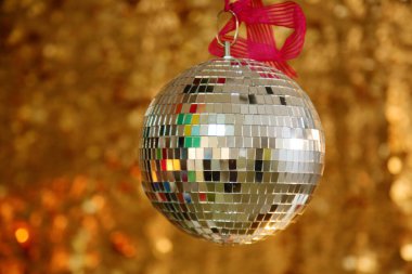 Silver Mirror Ball with Gold Sequin Background. Disco Ball with Gold backdrop. Disco Party. Dance Party.
