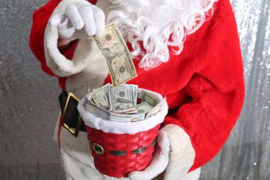 Santa Claus. Christmas Charity and Donations. Santa collects money for the needy or donations for the poor.