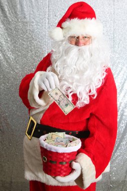 Santa Claus. Christmas Charity and Donations. Santa collects money for the needy or donations for the poor.