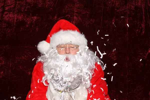 Santa Claus Santa Claus Blows Shredded Paper His Hands Photo — Zdjęcie stockowe
