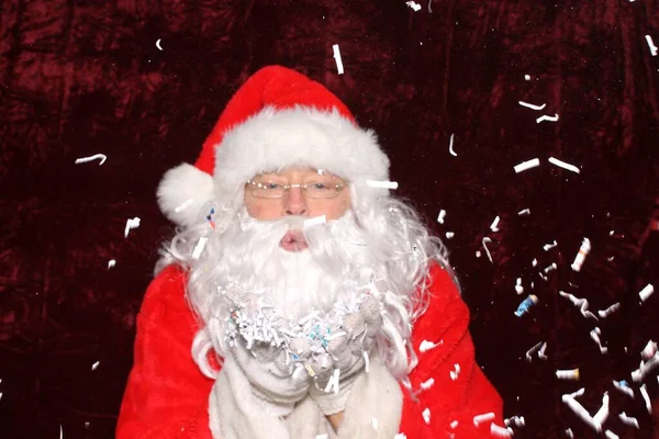Santa Claus Santa Claus Blows Shredded Paper His Hands Photo — стокове фото