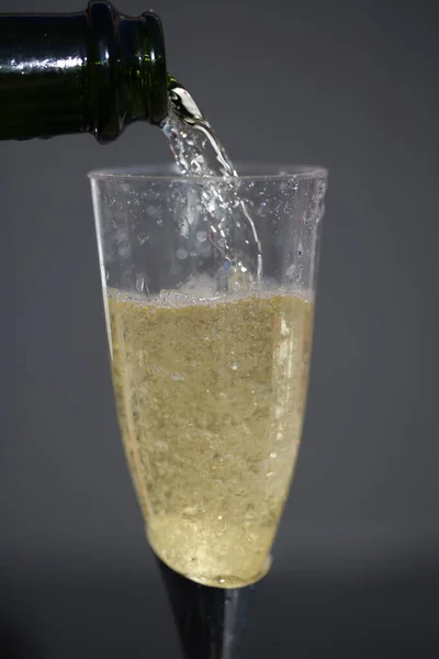 Champagne Close Up. Champagne Bubbles. Champagne. Pouring Champagne into a glass. Glass of Champagne.