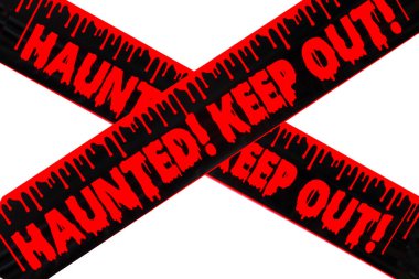 HAUNTED! KEEP OUT! Haunted. Keep Out Caution Tape. Halloween Decorations. Stay Out. Warning. Danger Keep Out Crime Strip Scene Halloween Night In Haunted House. Scary sign outside. Halloween. Keep Out