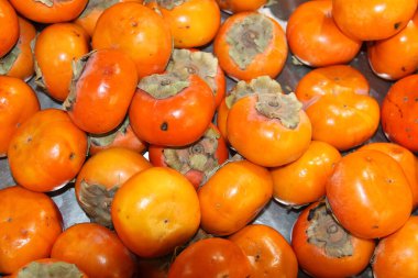 Hurma. Taze toplanmış hurmalar satın alınmak üzere üst üste yığıldı ve yemek için eve götürüldü. Hurmalar birçok özel yemek, yemek, aperatif ve tatlılarda popülerdir.. 