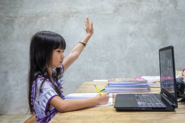 Thai girls study online at home to prevent the spread of COVID-19
