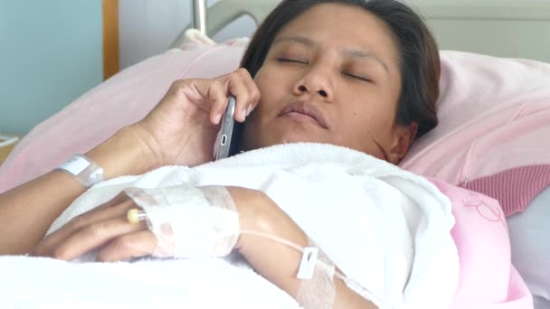 Paziente femminile in letto d'ospedale utilizzando il telefono — Video Stock